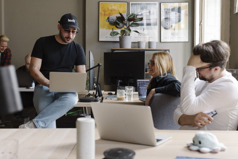 A team of web designers, UI/UX designers and web developers having a meeting at Wanted For Nothing tech & design agency